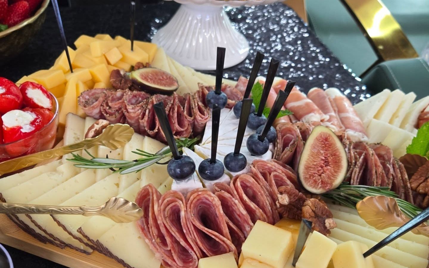 Cheeses, cured meats, and figs on a grazing board